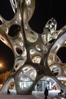Breathtaking 3D Printed Layered Facades of Modern Architectural Building at Night with Intricate Geometric Designs photo