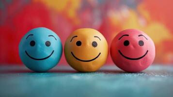 Three Colorful Smiley Balls Displaying Positive Emotions Against a Vibrant Background photo