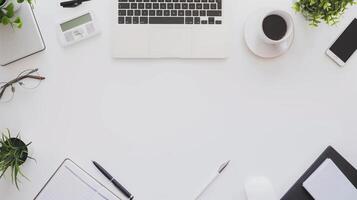 Top View of a Professional Marketing Manager's Desk with Laptop, Coffee, Notebook, and Green Plants photo