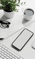 White Minimalist Smartphone Mockup on Desk with Coffee, Glasses, and Plant in Clean Workspace Setting photo