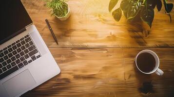 Modern Workspace with Laptop, Coffee, and Plants on Wooden Desk in Professional Office Setting photo