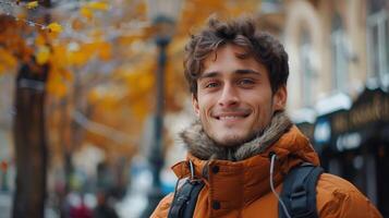 Young Man Smiling Outdoors in Autumn, Wearing Jacket with Leafy Background photo