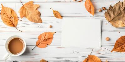 Autumn Mockup with Blank Card, Fall Leaves, and Coffee on White Wooden Table photo