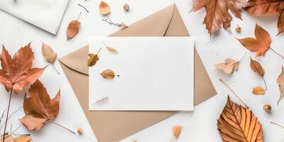 Blank Greeting Card Mockup with Autumn Leaves and Envelopes photo