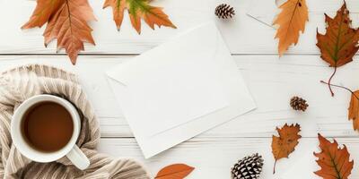 Autumn-Themed Stationery Mockup with Blank Envelope, Fall Leaves, Hot Drink, and Sweater photo
