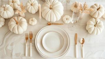 Elegant Thanksgiving Table Setting with White Pumpkins and Gold Cutlery photo