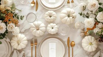 Elegant Thanksgiving Dinner Table Setting with White Pumpkins and Floral Decorations photo