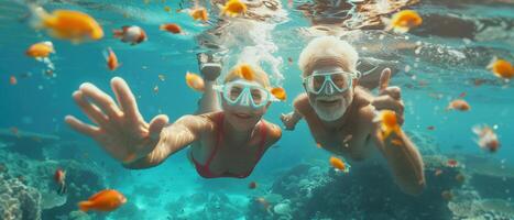 Senior Couple Snorkeling in Tropical Waters Surrounded by Colorful Fish photo