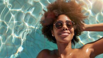 Cheerful Woman Enjoying Sunny Day Relaxing in Pool with Sunglasses photo