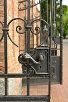 a close up of a wrought iron gate photo