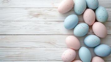 Happy Easter holiday background with colorful pastel eggs on white wooden table, top view, copy space photo