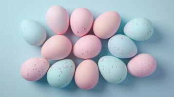 Happy Easter holiday background with colorful pastel eggs on blue paper, top view, copy space photo