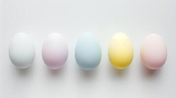 Happy Easter holiday background with colorful pastel eggs on white paper, top view photo
