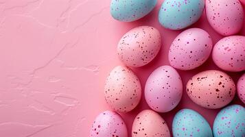 Copy space Happy Easter holiday background with colorful pastel eggs on pink stone, top view photo