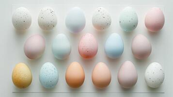Happy Easter holiday background with colorful pastel eggs on white paper, top view photo