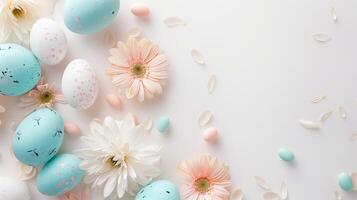 Easter pastel colored eggs with spring flowers on white background, copy space, top view photo