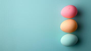 Happy Easter holiday background with colorful pastel eggs on blue paper, top view, copy space photo