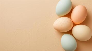 Happy Easter holiday background with colorful pastel eggs on beige paper, top view, copy space photo