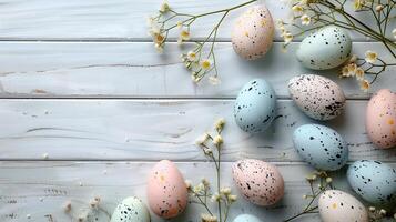 Easter pastel eggs with spring flowers on pastel wooden blue background with copy space, top view photo