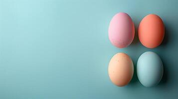 Happy Easter holiday background with colorful pastel eggs on blue paper, top view, copy space photo