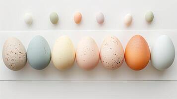 Happy Easter holiday background with colorful pastel eggs on white paper, top view photo