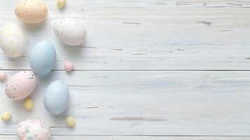 Happy Easter holiday background with colorful pastel eggs on white wooden table, top view, copy space photo