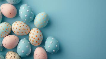 Happy Easter holiday background with colorful pastel eggs on blue paper, top view, copy space photo