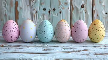 Easter pastel eggs on pastel wooden blue background with copy space, flat lay composition photo
