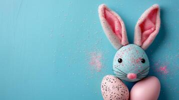 Easter flat lay composition. Bunny ears and Easter eggs on a blue background top view photo