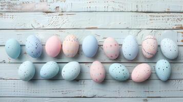 Happy Easter holiday background with colorful pastel eggs on white wooden table, top view, copy space photo