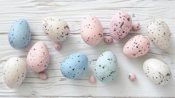 Happy Easter holiday background with colorful pastel eggs on white wooden table, top view, copy space photo