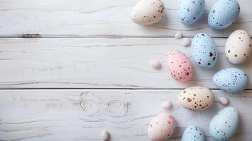 Happy Easter holiday background with colorful pastel eggs on white wooden table, top view, copy space photo