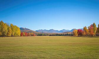 Scenic fall scenery, open field, colorful trees, distant mountains photo