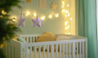 White crib with starry mobile photo