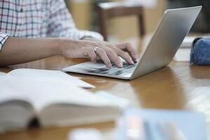 Student Studying Online Using Laptop in Library photo