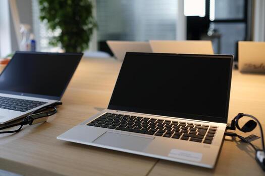 Laptops on a table in a co-working space photo