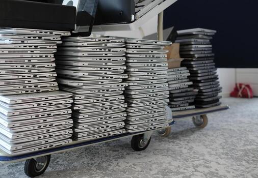 Stack of laptops in the storage room of a company photo