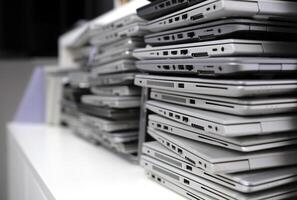 Stack of laptops in the storage room of a company photo