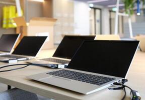 Laptops on a table in an empty co-working space photo