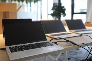 Laptops on a table in an empty co-working space photo