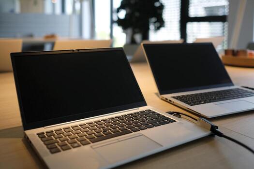 Laptops on a table in a co-working space photo