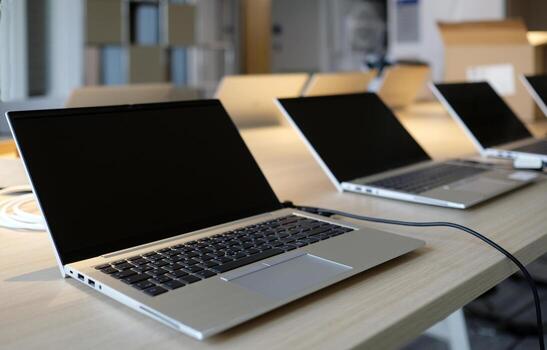 Laptops on a table in a co-working space photo