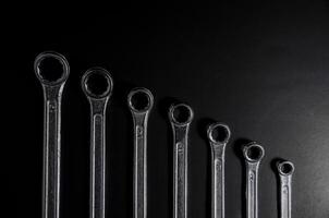 silver wrench sort by small to large on dark light on top view photo