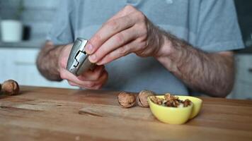 hands of a man cracking walnuts with a nutcracker video