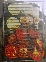 Onions and tomatoes on the grill with this vibrant of onions nd tomatoes that stimulate the barbecue photo