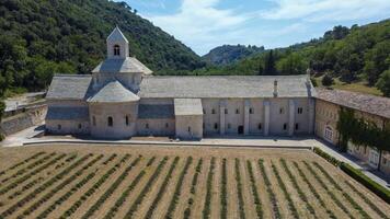 Cistercian Abbey of Senanque in Provence, a place of tranquility and prayer among mountains, trees and lavender fields. Ancient abbey founded in the 12th century by a monastic order. photo