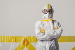 A health care worker in protective gear stands confidently in the lab photo