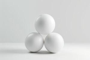 Three white spheres arranged in a triangle on a minimalistic background photo