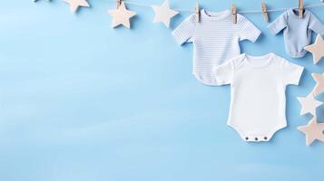 Pastel blue baby onesies hanging on line banner background copy space. Soft star ornaments image backdrop empty. Airy nursery vibes. Babyhood concept composition front view, copyspace photo