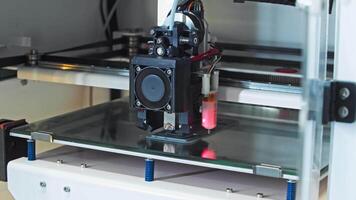 Close-up view of the working area of a high-precision 3D printer as it is printing a small component. Slow motion. video